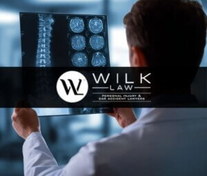 Doctor reviewing x-rays of a spinal cord injury in Philadelphia related to a case handled by Wilk Law Personal Injury & Car Accident Lawyers