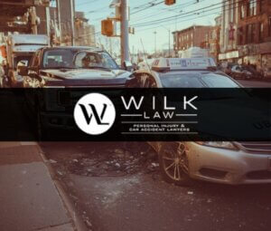 Accident involving an Uber vehicle and a pickup truck near shops in Philadelphia, Pennsylvania, related to a case handled by Wilk Law Personal Injury & Car Accident Lawyers