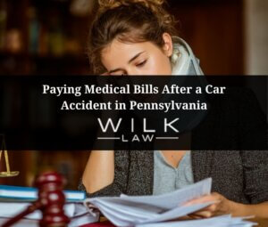 Woman with a neck brace on looking over medical bills after a car accident in Pennyslvania