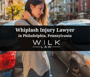 Woman standing next to her crashed car holding the back of her neck in pain in Philadelphia, Pennsylvania