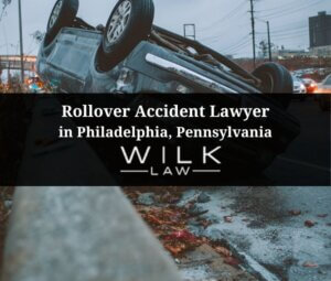 Crashed car flipped upside down next to a highway median in Philadelphia, Pennsylvania