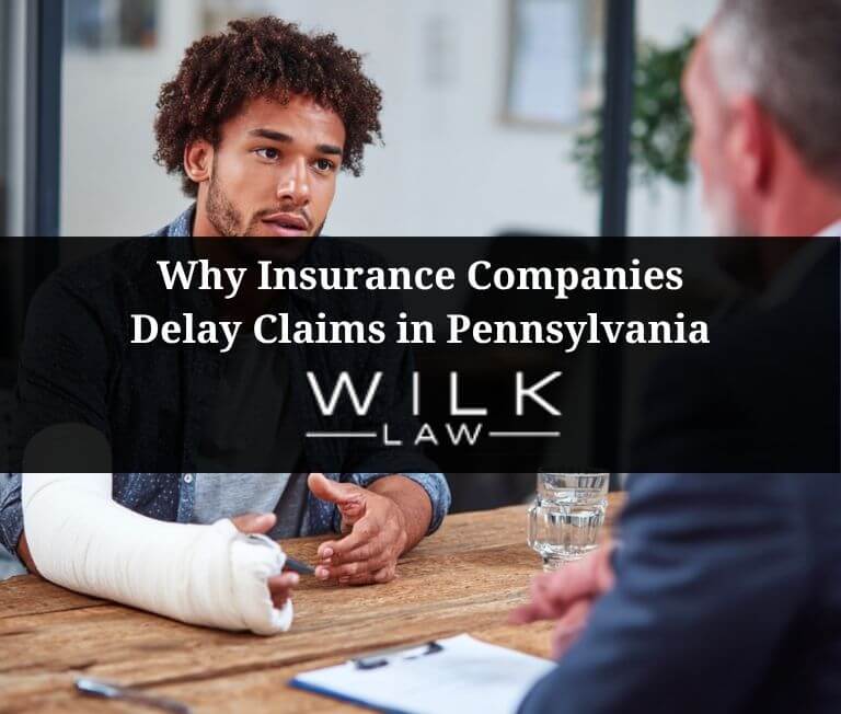 Young man speaking with an insurance company adjuster about why his claim is being delayed in Pennsylvania