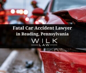 Car crash on a highway in Reading, Pennsylvania, EMTs assisting injured victim in the background