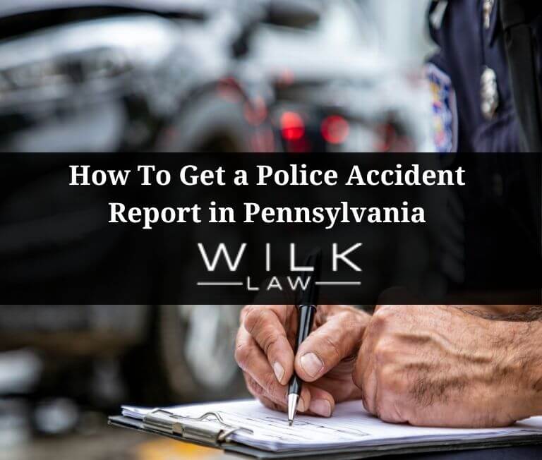 Pennsylvania police officer taking notes at the scene of a car accident