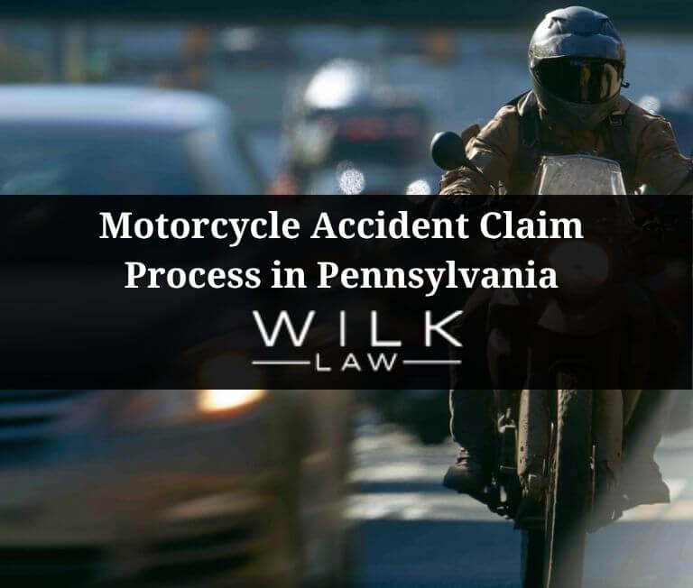 Motorcycle rider passing a car in traffic in Philadelphia, Pennsylvania