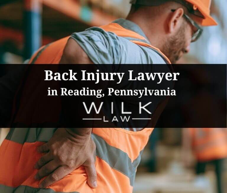 Warehouse worker with a strained back in pain in Reading, Pennsylvania related to a case handled by Wilk Law Personal Injury & Car Accident Lawyers