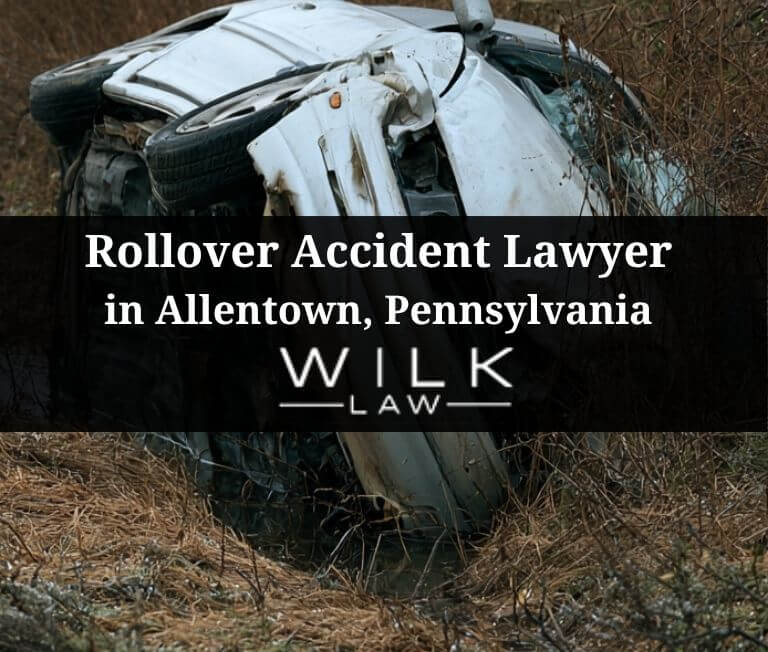 Crashed car on its side in a ditch next to the highway in Allentown, Pennsylvania